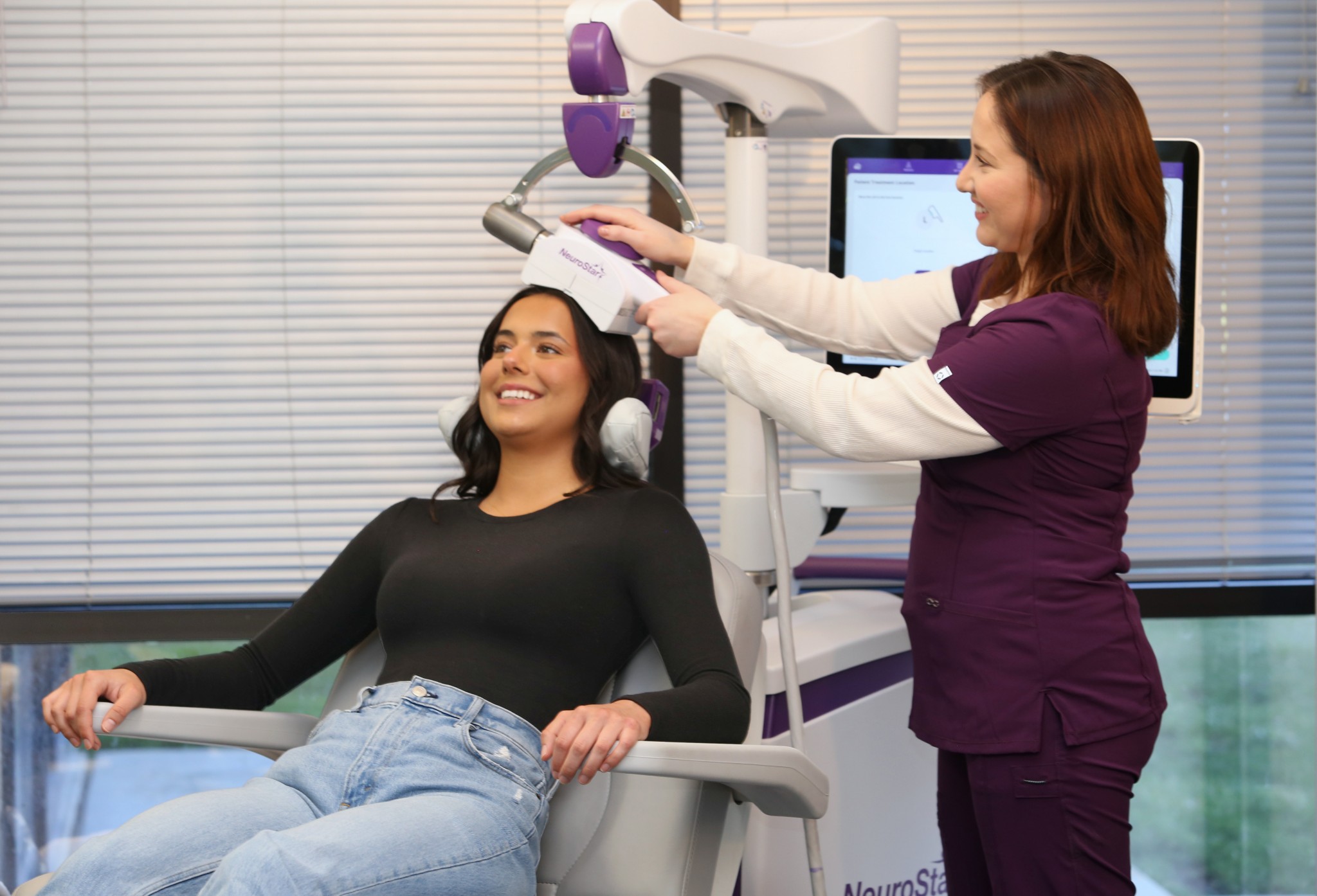 How Long Does TMS Last and What Maintenance Care Involves 2 Clinical provider operating the NeuroStar touch screen console during a session.